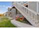 Exterior view showing stairs leading to a deck, two orange chairs, and a walkway at 16293 Mount Mestas Way, Broomfield, CO 80023