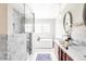 Luxurious bathroom featuring marble finishes, a glass shower, and dual vanities at 4530 S Verbena St # 316, Denver, CO 80237