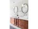 Elegant bathroom vanity with dual sinks, decorative mirrors, and stylish lighting at 4530 S Verbena St # 316, Denver, CO 80237