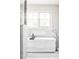 Modern freestanding bathtub next to the shower with large window at 4530 S Verbena St # 316, Denver, CO 80237