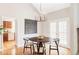 Tastefully designed dining space with hardwood floors, a round table, and access to the kitchen, ideal for gatherings at 4530 S Verbena St # 316, Denver, CO 80237