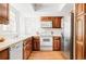 Traditional kitchen with wooden cabinets, white appliances, and natural light, offering a functional cooking space at 4530 S Verbena St # 316, Denver, CO 80237