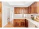 Traditional kitchen with custom wood cabinetry and white countertops at 4530 S Verbena St # 316, Denver, CO 80237