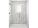 Shower with marbled walls and a rainfall shower head at 4530 S Verbena St # 316, Denver, CO 80237