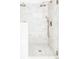 Shower featuring floor-to-ceiling marble tiles and a rainfall shower head at 4530 S Verbena St # 316, Denver, CO 80237