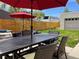 Inviting backyard featuring patio seating, a wooden fence, and well-maintained grass, perfect for relaxing and entertaining at 4351 Yates St, Denver, CO 80212
