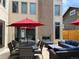 Expansive backyard patio featuring an outdoor fireplace, dining table, and comfortable seating at 4351 Yates St, Denver, CO 80212