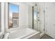 Bright bathroom with a soaking tub, glass-enclosed shower, and contemporary design at 4351 Yates St, Denver, CO 80212
