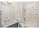 Bright bathroom showcasing a vanity with storage, combined tub and shower, and tiled accents at 4351 Yates St, Denver, CO 80212