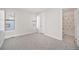 An airy bedroom with neutral carpet, two windows letting in natural light, and an ensuite bathroom at 4351 Yates St, Denver, CO 80212