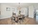 Bright dining room featuring hardwood floors, modern light fixture, and natural light from nearby windows at 4351 Yates St, Denver, CO 80212