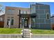 Modern home with a combination of brick and gray siding and well-manicured front lawn at 4351 Yates St, Denver, CO 80212