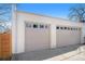 Two-car garage exterior featuring neutral-colored doors and modern design at 4351 Yates St, Denver, CO 80212