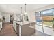 Bright kitchen with gray island, stainless steel appliances, and sliding doors to patio at 4351 Yates St, Denver, CO 80212