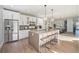 Spacious kitchen with a center island, stainless steel refrigerator, and open floor plan to dining area at 4351 Yates St, Denver, CO 80212