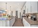 Well-lit kitchen featuring a center island, stainless steel appliances, and sleek white cabinetry at 4351 Yates St, Denver, CO 80212