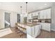 Modern kitchen features white cabinets, a large island with seating, and stainless steel appliances at 4351 Yates St, Denver, CO 80212