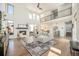 Expansive living room with a fireplace, hardwood floors, and abundant natural light from large windows at 4351 Yates St, Denver, CO 80212