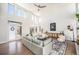 Airy living room with hardwood floors, stylish decor, and lots of natural light from large windows at 4351 Yates St, Denver, CO 80212