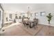 Open-concept living space with a modern dining table, kitchen, and lots of sunlight at 4351 Yates St, Denver, CO 80212