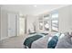 Sunlit main bedroom featuring plush carpet, and multiple windows with neighborhood views at 4351 Yates St, Denver, CO 80212