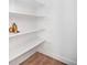 Walk-in pantry features white shelving, decor, and wood flooring at 4351 Yates St, Denver, CO 80212