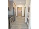 Hallway includes stainless steel refrigerator, range, and stacked washer and dryer at 603 Inca St # 429, Denver, CO 80204