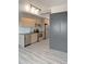 Modern kitchen with stainless steel appliances, light wood cabinets, and a gray luxury vinyl tile flooring at 603 Inca St # 429, Denver, CO 80204