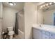 Bathroom featuring white tile bathtub and a vanity with double sinks at 7440 S Blackhawk St # 4-102, Englewood, CO 80112