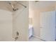 Bathroom showcasing tiled shower, white vanity with countertop, and tile flooring at 7440 S Blackhawk St # 4-102, Englewood, CO 80112