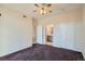Bedroom with neutral paint and plush carpet, featuring bathroom and closet entrances at 7440 S Blackhawk St # 4-102, Englewood, CO 80112