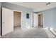 Bedroom with light blue walls, carpet and natural light through open doorway at 7440 S Blackhawk St # 4-102, Englewood, CO 80112