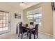 Cozy dining area with dark wood table set and natural light streaming in from large window at 7440 S Blackhawk St # 4-102, Englewood, CO 80112