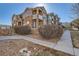 Charming exterior view of the brownstone-style apartment building featuring stone accents and inviting balconies at 7440 S Blackhawk St # 4-102, Englewood, CO 80112