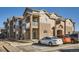 Exterior view of a multi-story building with stone accents, balconies, and designated parking spaces at 7440 S Blackhawk St # 4-102, Englewood, CO 80112