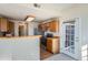 Functional kitchen with stainless steel appliances, tile countertops, and natural wood cabinets at 7440 S Blackhawk St # 4-102, Englewood, CO 80112