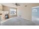 Bright living room featuring a fireplace, large windows, and neutral carpet, offering a cozy and inviting atmosphere at 7440 S Blackhawk St # 4-102, Englewood, CO 80112