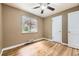 Bedroom with hardwood floors, natural light from the window, and a closet at 1691 Poplar St, Denver, CO 80220