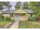 Charming single-story brick home with a covered porch, walkway, and mature trees in a quiet neighborhood at 1691 Poplar St, Denver, CO 80220