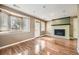 Cozy Gathering room with a fireplace, bay window, and hardwood flooring at 1691 Poplar St, Denver, CO 80220