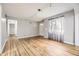 Spacious living room with hardwood floors, neutral paint, and large windows filling the room with natural light at 1691 Poplar St, Denver, CO 80220