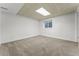 Spacious carpeted basement area with a drop ceiling and a small window for natural light at 11542 Community Center Dr # 56, Northglenn, CO 80233