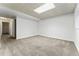Unfinished basement space features neutral carpet and drop ceiling with limited natural light at 11542 Community Center Dr # 56, Northglenn, CO 80233