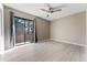 Bedroom featuring hardwood floors, a ceiling fan, and a sliding glass door with gray curtains at 11542 Community Center Dr # 56, Northglenn, CO 80233