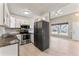 Well-lit kitchen featuring granite countertops, stainless steel appliances, and ample cabinet storage at 11542 Community Center Dr # 56, Northglenn, CO 80233