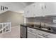 Bright kitchen with wood flooring, granite counters, stainless steel appliances, and staircase at 11542 Community Center Dr # 56, Northglenn, CO 80233