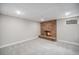 Finished basement boasts a cozy brick fireplace and neutral carpet at 8022 W 78Th Way, Arvada, CO 80005