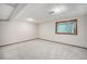 Neutral-colored basement with carpet flooring, window and base trim at 8022 W 78Th Way, Arvada, CO 80005