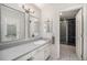 Bathroom featuring a double vanity and a glass-enclosed walk-in shower at 8022 W 78Th Way, Arvada, CO 80005