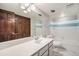 Bright bathroom with a clean white vanity, shower, and built in wardrobe at 8022 W 78Th Way, Arvada, CO 80005